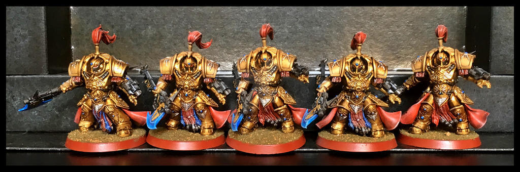 Adeptus Custodes painted models - five in a row, gold armor.